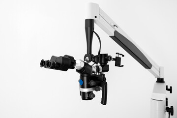 Microscope in a dental office photographed on a white background.