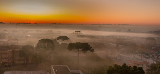 The rising sun struggling to break the morning haze