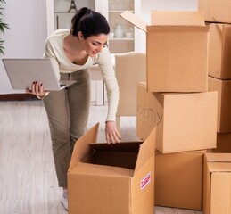 Young woman moving to new flat