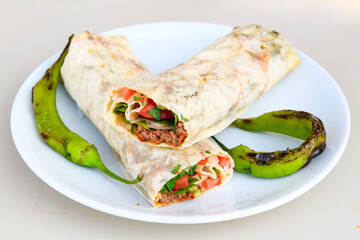 Lavash doner kebab ( zurna tavuk et doner durum )  or shawarma sliced in plate isolated. 