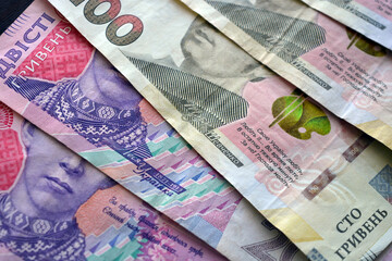 Bright, freshly printed money, large banknotes of 100 and 200 Ukrainian hryvnias. The money of...