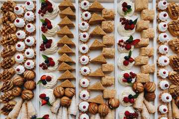 Beautifully decorated catering banquet table with different food snacks and appetizers