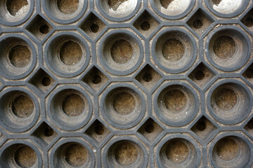 Unusual rubber gray rug consisting of unusual, deep textured holes, abstract background.