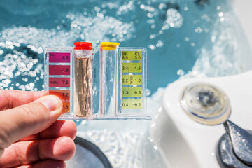 Hot Tub Water Quality Check by Using Chemical Testing Kit. - obrazy, fototapety, plakaty