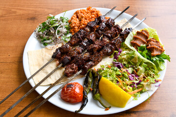 Beef steak grill with rice pilaf, fried potatoes, grilled pepper and tomatoes.Mix Platter with Beef rips, Cutlets, Potatoes and Sauces.