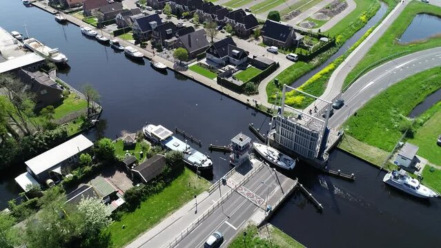 Aerial view of picturesque dutch city Lemmer and bascule bridge in the summer. Sailboats and yachts pass under the drawbridge. Famous place to visit in Holland. 