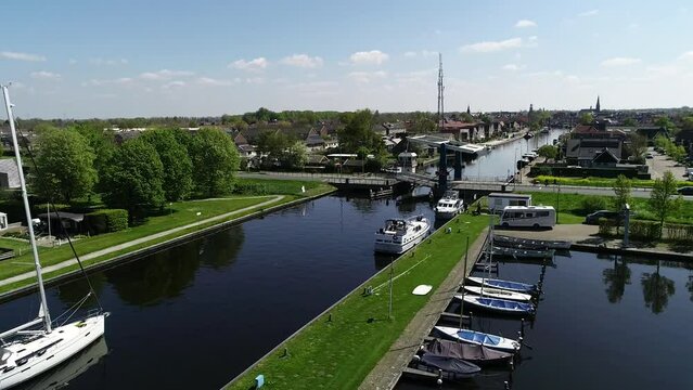 Aerial view of picturesque dutch city Lemmer and bascule bridge in the summer. Sailboats and yachts pass under the drawbridge. Famous place to visit in Holland. 