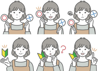 〇✕マークや初心者マークを持つエプロンの中年女性