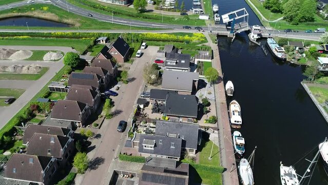 Aerial view of picturesque dutch city Lemmer and bascule bridge in the summer. Sailboats and yachts pass under the drawbridge. Famous place to visit in Holland. 