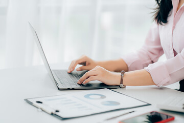 Fototapeta premium Business woman sitting using laptop computer with on the desk in the office