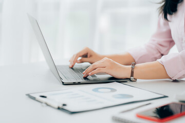 Business woman sitting using laptop computer with on the desk in the office