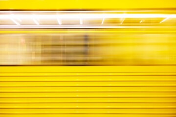 Long exposure of a yellow u-bahn in Berlin station