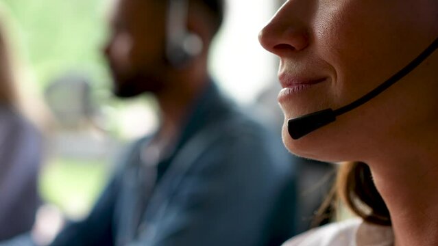 Young woman customer care support service agent call center operator in wireless headset talk consult online client using computer solving complaints on helpline or sell services in telesales office