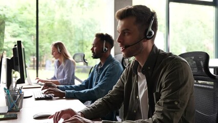 Male representative call center agent in wireless headset helping client, operator working in customer support service
