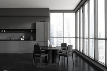 Kitchen interior with dining table and chairs, kitchenware and panoramic window