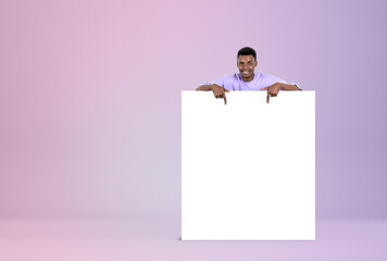 African man fingers pointing at mockup canvas on lilac background