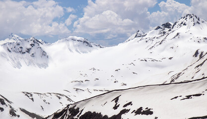 Panorama of a colored mountain landscape with the snow covered mountains - 521812089