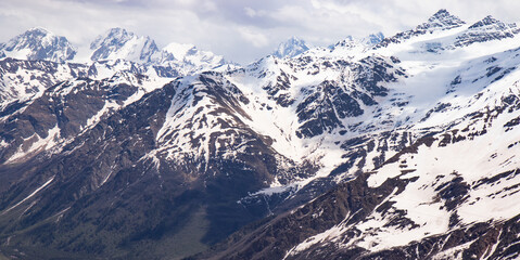 Panorama of a colored mountain landscape with the snow covered mountains - 521812475