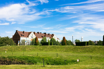 Fototapeta na wymiar Country house under blue sky with white clouds and green lawn