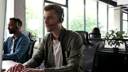 Male representative call center agent in wireless headset helping client, operator working in customer support service
