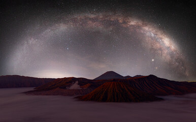 Beautiful night landscape with silhouette of Bromo mountain on the background Milky way galaxy - Bromo Tengger Semeru National Park , Indonesia