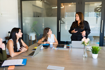 Plus size young woman with her working team during a meeting