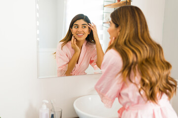 Cheerful woman looking happy with her skin care routine