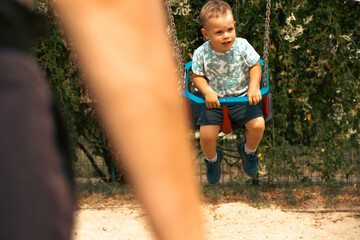 Grandmother and child having fun together, playing on a swing. Generation and childhood concept. Happy family symbol.