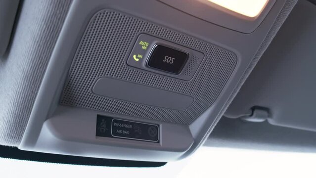 Seat belt warning panel, emergency call button and lamp on roof of modern car