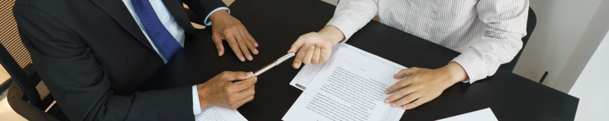 Lawyer and justice concept, Businessman receives a pen from senior lawyer to signing contract