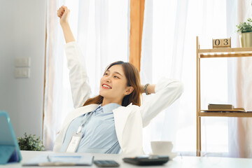 Successful business concept, Businesswoman raising arm to stretching after hard working new project - Powered by Adobe