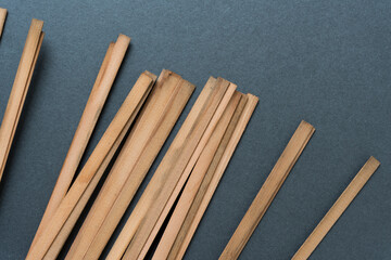 tips of vintage cedar wood straps on blank paper