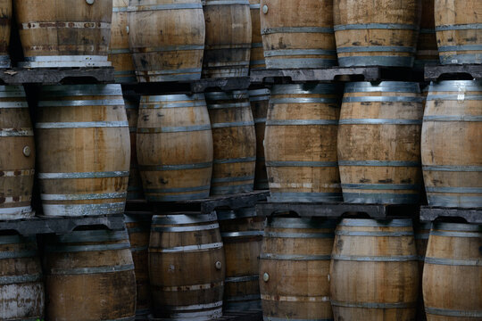 Wooden barrels stacked on pallets, Spanish wine barrel, oak