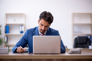 Young male employee working in the office