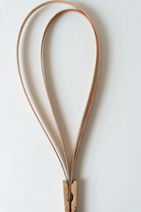 two vintage cedar wood straps bent in an elegant hoop and held in place with a clothespin clip