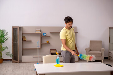 Young man doing housework at home