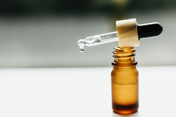 Fototapeta na wymiar Amber bottle with serum or essential oil