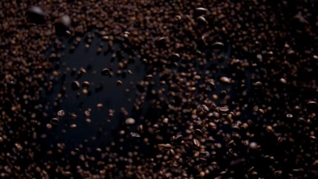 Magic falling coffee grains on dark background. Premium roasted beans flying.