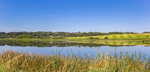 Panorama of a lake in the rolling landscape of Hobro