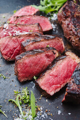Barbecue dry aged wagyu roast beef steak with lettuce and spice served as close-up on a rustic...