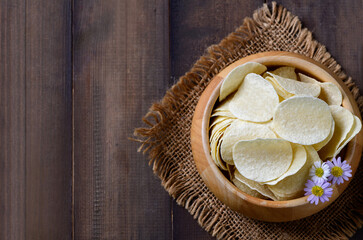 Top view of Potato chips bowl on wood background with copy space, fat food or junk food