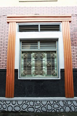 Classic window, a combination of iron trellis, wood and brick walls.