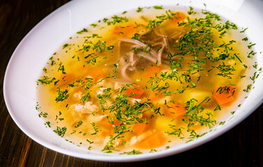 Bowl of meat and vegetable soup on a table