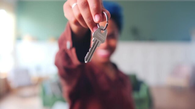 Keys to apartment or house in hand woman close-up symbolize renting or buying real estate for permanent residence or obtaining mortgage with subsequent payment for investment purposes. Selective blur