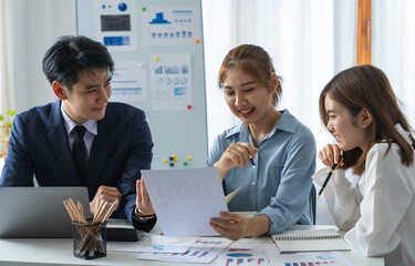 Asia business group meeting and discuss new startup concept projects Business team planning, strategic analysis and brainstorming with office paper reports.