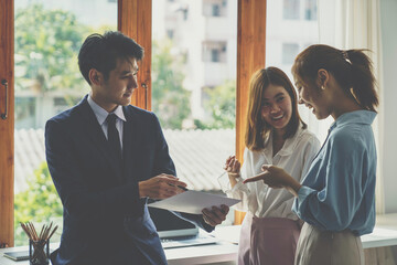 Asia business group meeting and discuss new startup concept projects Business team planning, strategic analysis and brainstorming with office paper reports.