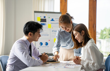 Fototapeta premium Asia business group meeting and discuss new startup concept projects Business team planning, strategic analysis and brainstorming with office paper reports.