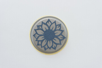 sunflower cutout on a metal lid with blank space