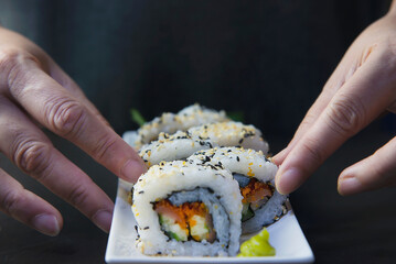 japanese sushi roll serving in oriental restaurant, chef is preparing japan tradition cookery menu, various different assorted luxury mixed healthy eating set concept