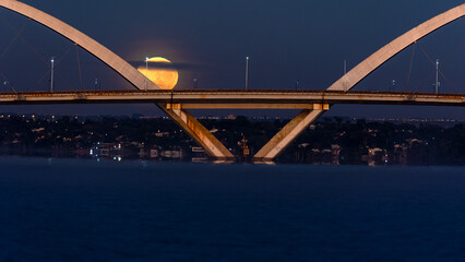 The moon sunset over the JK Bridge in Brasilia, Brazil. Supermoom.